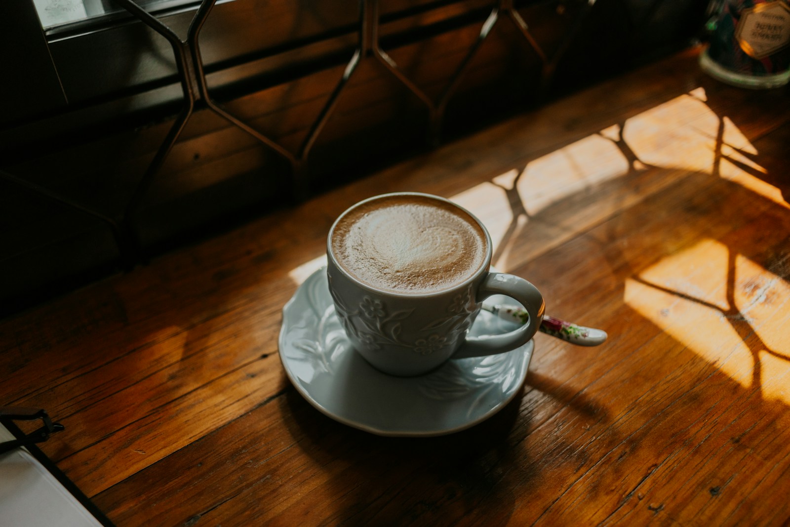 A cup of coffee sitting on top of a wooden table